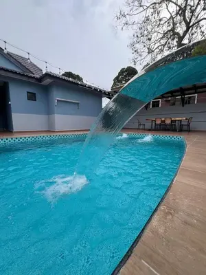 a water fountain in a swimming pool at Eiffel Villa Homestay Melaka in Gua Sai