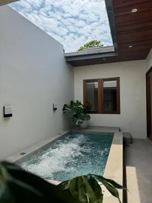a swimming pool in a house with a skylight at Shinju Villa with Jacuzzi Pool in Jelutong