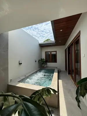 a swimming pool in a house with a skylight at Shinju Villa with Jacuzzi Pool in Jelutong