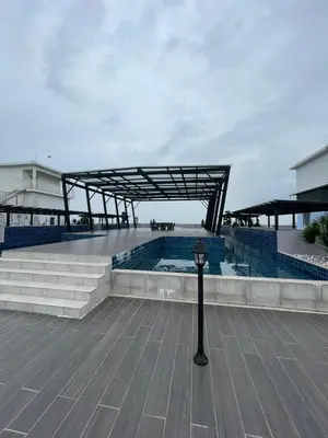 a building with a swimming pool and a light pole at Wake Up Above The City Lights in Sitiawan