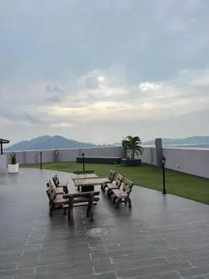a group of benches and a table on a patio at Wake Up Above The City Lights in Sitiawan