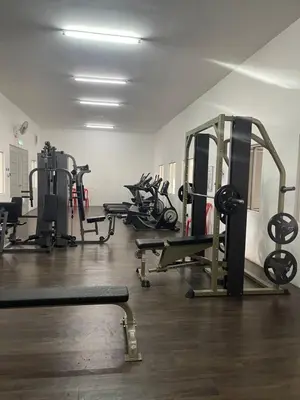 a gym with several treadms and machines in a room at Wake Up Above The City Lights in Sitiawan
