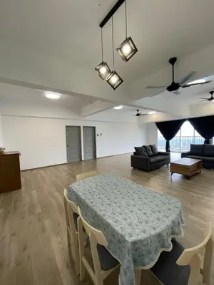 a living room with a table and a couch at Wake Up Above The City Lights in Sitiawan