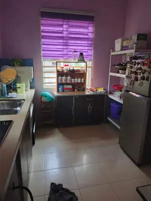 a kitchen with a refrigerator and a window with purple walls at Jannah Paddyview homestay
