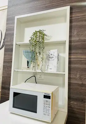 a microwave oven sitting on a counter with a mirror at Woodsbury Suites Butterworth in Butterworth