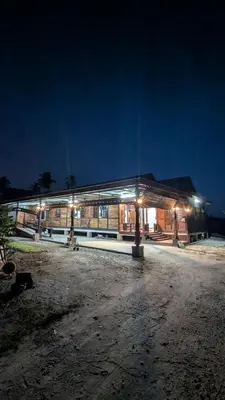 a building with lights in front of it at night at Abadi's Homestay in Tanjung Karang
