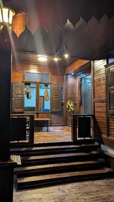 a room with wooden walls and stairs in a building at Abadi's Homestay in Tanjung Karang