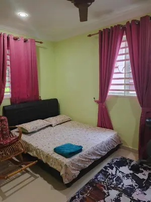 a bedroom with a bed with purple drapes at Jannah homestay paddyview
