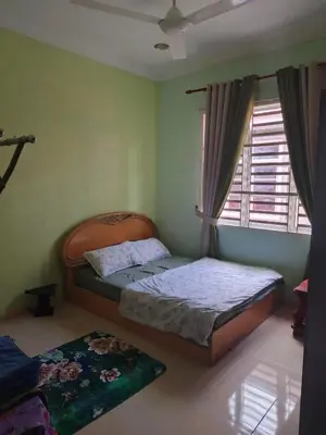 a bedroom with two beds and a window at Jannah homestay paddyview