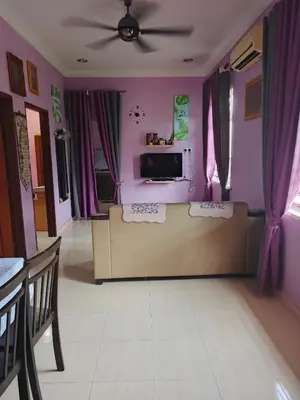 a living room with purple walls and a couch at Jannah homestay paddyview