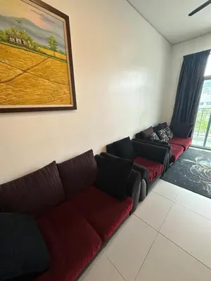 a living room with two couches and a painting on the wall at AYAAN MARIGOLD at Golden Hills Night Market View in Brinchang