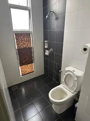 a bathroom with a white toilet and a window at AYAAN AURORA at Golden Hill Near Night Market and Free Parking in Brinchang