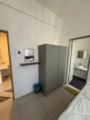 a white room with a bed and a mirror at AYAAN AURORA at Golden Hill Near Night Market and Free Parking in Brinchang