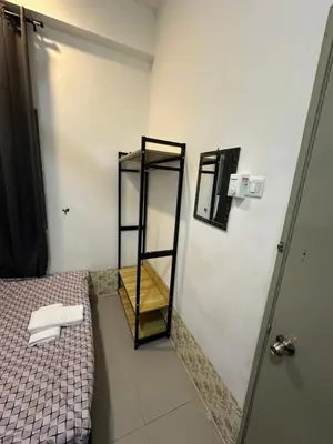 a small bathroom with a bed and a mirror at AYAAN AURORA at Golden Hill Near Night Market and Free Parking in Brinchang