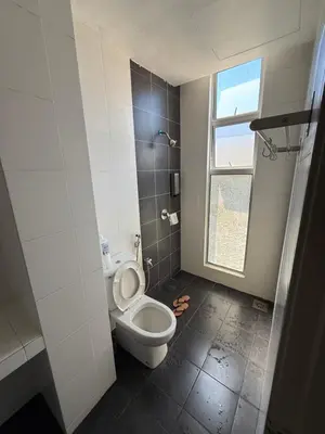 a bathroom with a toilet and a window at AYAAN AURORA at Golden Hill Near Night Market and Free Parking in Brinchang