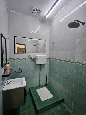 a bathroom with a sink and a toilet in it at Teratak Abah in Seri Manjung
