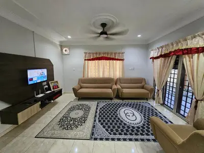 a living room with a couch and a tv at Teratak Abah in Seri Manjung