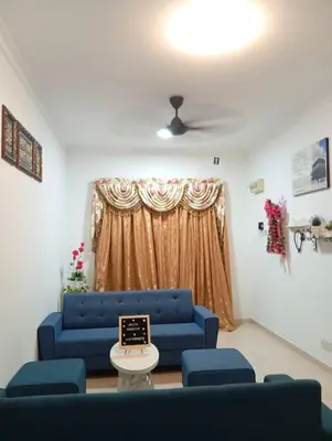 a living room with a blue couch and blue chairs at Auliya Homestay in Gua Sai