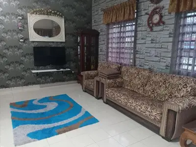 a living room with a couch and a tv at Homestay Manjoi - muslim2 in Ipoh
