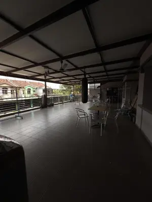 a dining area with a table and chairs on a roof at MM HomeStay 82 in Kamunting
