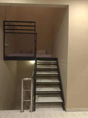 a staircase in a room with a bunk bed at MM HomeStay 82 in Kamunting