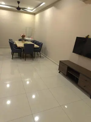 a dining room with a table and chairs and a flat screen tv at MM HomeStay 82 in Kamunting