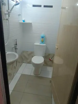 a bathroom with a toilet and a sink at Cream Roof Homestay in Gua Sai