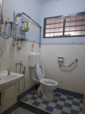 a bathroom with a toilet and a sink at ACACIA GUESTHOUSE by Zamanja in Ipoh