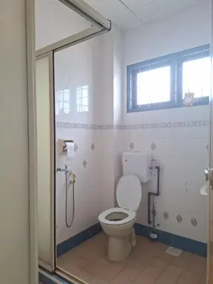 a bathroom with a toilet and a shower stall at ACACIA GUESTHOUSE by Zamanja in Ipoh