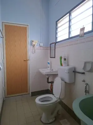 a bathroom with a toilet and a sink and a window at ACACIA GUESTHOUSE by Zamanja in Ipoh