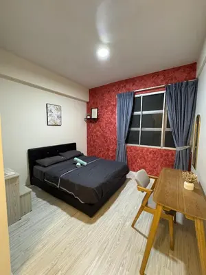 a bedroom with a black bed and a red wall at Pillow Talk HQ in Gua Sai