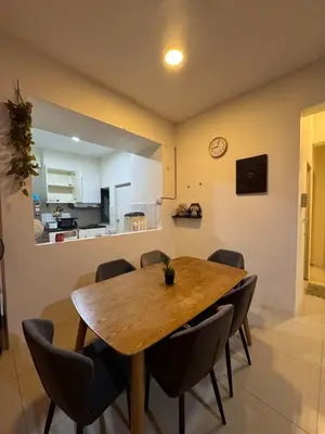 a dining room with a wooden table and chairs at Pillow Talk HQ in Gua Sai