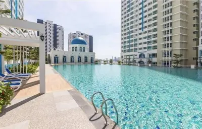 a large swimming pool in a city with buildings at Hide-out in Tanjong Tokong