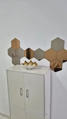 a white cabinet with brown boxes on top of it at Hide-out in Tanjong Tokong