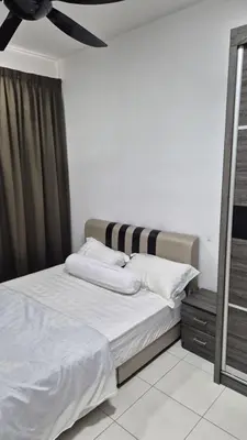 a bedroom with a bed with white sheets and a ceiling at Hide-out in Tanjong Tokong