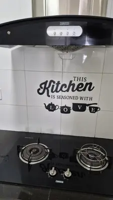 a black and white microwave with a sign on it at Hide-out in Tanjong Tokong