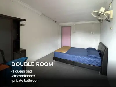 a bedroom with a blue bed in a room at Villa Warisan Homestay