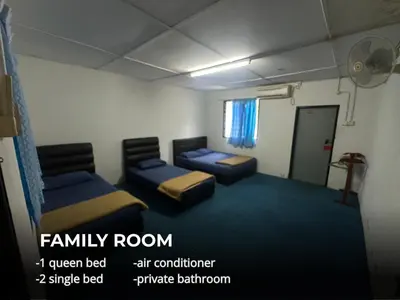 a living room with two beds and a room with a room at Villa Warisan Homestay