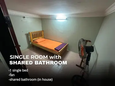 a small room with a small bed and a camera at Villa Warisan Homestay