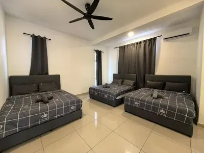 two beds in a room with a ceiling fan at Padang Serai Wangi Homestay 95 in Padang Serai