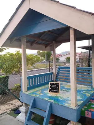a blue bench with a sign on it at Auliya homestay in Gua Sai