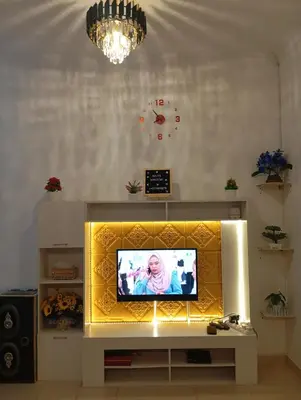 a television in a living room with a yellow screen at Auliya homestay in Gua Sai