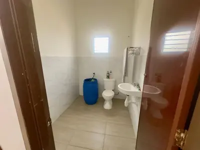 a bathroom with a toilet and a sink at homestay juliana rinching tengah in Gua Sai
