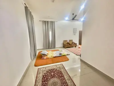 a living room with a bed and a couch at homestay juliana rinching tengah in Gua Sai
