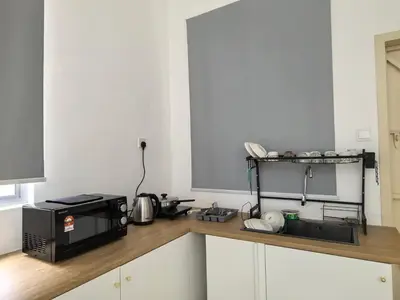 a kitchen with a microwave and a counter top at Padang Serai Wangi Homestay 91 in Padang Serai
