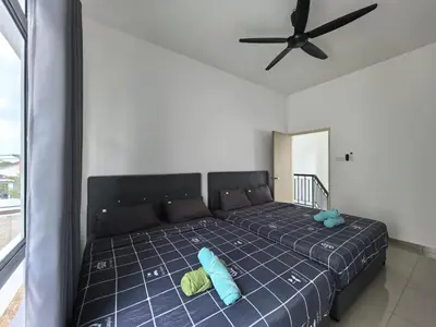 a bedroom with a bed with two pillows and a ceiling fan at Padang Serai Wangi Homestay 91 in Padang Serai