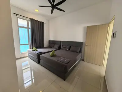 a bedroom with a bed and a ceiling fan at Padang Serai Wangi Homestay 91 in Padang Serai