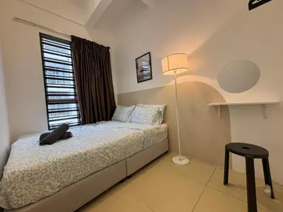 a bedroom with a bed with a lamp and a window at JS Comfortable Stay Golden Hills Pasar Malam 3Bedrooms 2Bathrooms in Brinchang