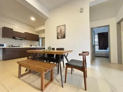 a kitchen and dining room with a table and chairs at JS Comfortable Stay Golden Hills Pasar Malam 3Bedrooms 2Bathrooms in Brinchang