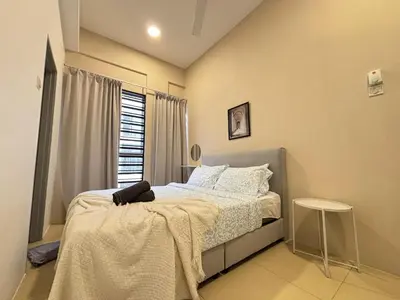 a bedroom with a bed with a blanket on it at JS Comfortable Stay Golden Hills Pasar Malam 3Bedrooms 2Bathrooms in Brinchang